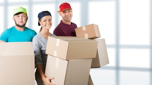 Removal workers carrying office furniture during a Blackfriars relocation